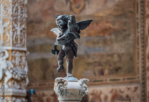 Sculpture of cupid with dolphin in the inside contryyard of a Palazzo Vecchio palace in the old Florence town, Italy.
