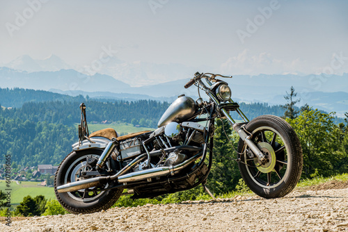 a classic chopper motorbike in the swiss countryside