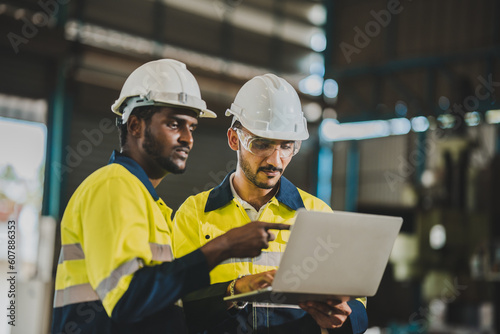 professional technician engineer with safety helmet hard hat working in industrial manufacturing factory, men at work to checking equipment of machinery production technology or construction operating