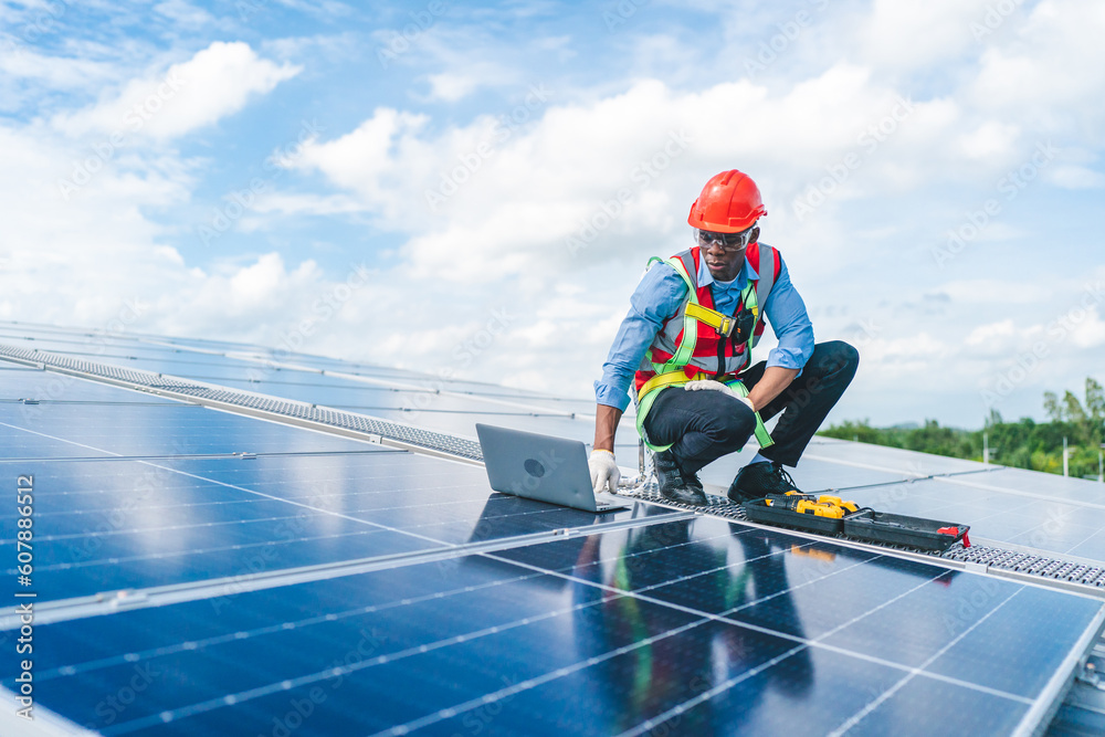 Male professional engineer installing solar photovoltaic panel system, Electrician mounting blue solar module technology on power industrial factory roof, Alternative energy ecological technician job Male professional engineer installing solar photovoltaic panel system, Electrician mounting blue solar module technology on power industrial factory roof, Alternative energy ecological technician job