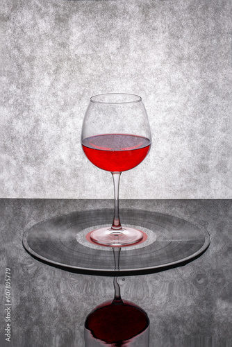 Still life with a glass of red wine on a vinyl record