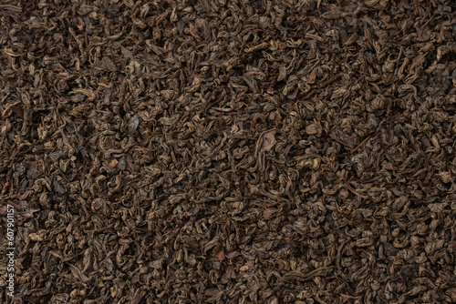 Dried tea leaves as a background.