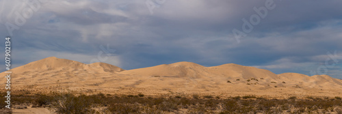 Panoramic landscape scenic view in Mojave Desert, California with Kelso Sand Dunes in view on blue sky day.