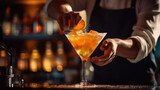 bartender making cocktail. slicing a long ribbon of lemon peel