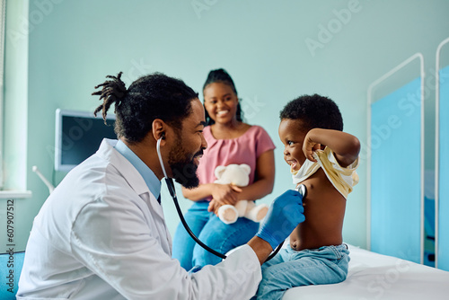 Happy black kid during medical examination at doctor's office.