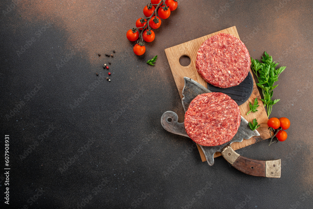 Raw cutlet for burger on a dark background, Restaurant menu, dieting, cookbook recipe top view