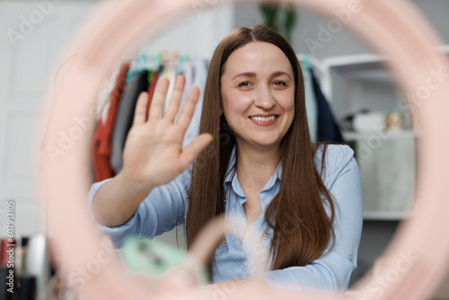 Mobile web camera view smiling young attractive caucasian woman waving hand, streaming stories online in social networks, vlogging recording selfie video, starting distant conversation