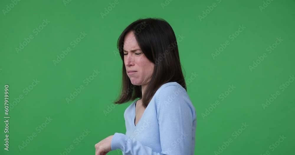 Caucasian woman standing on green screen, looking at the camera and seeing something repulsive, making a disgusted face and rejecting whatever it is. Her facial expression clearly conveys her disgust. Caucasian woman standing on green screen, looking at the camera and seeing something repulsive, making a disgusted face and rejecting whatever it is. Her facial expression clearly conveys her disgust.