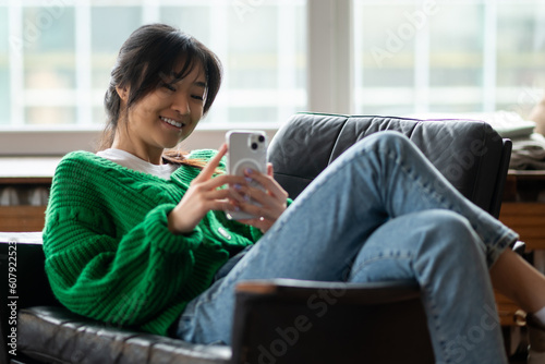 Cute young girl with a smartphone spending time on internet