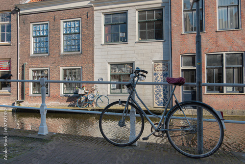 Canals, Brick Houses, Parked Bicycles in Delft, Netherlands © Belus
