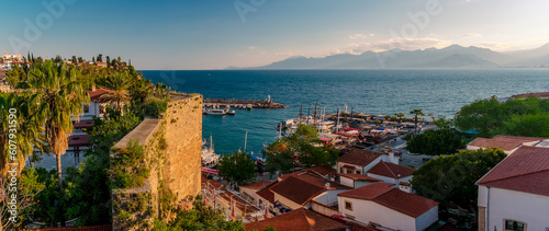 Panorama view from a high point on part of the fortress wall and the old port of Kaleichi in the Turkish city of Antalya. Panoramic view of part of the fortress wall and the old port in the tourist a