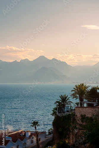 View of the mountains  sea and palm trees in the Turkish city of Antalya. Evening in Antalya. Evening in Antalya.