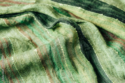 Green scarf fabric texture. Coarse twisted fabric, background