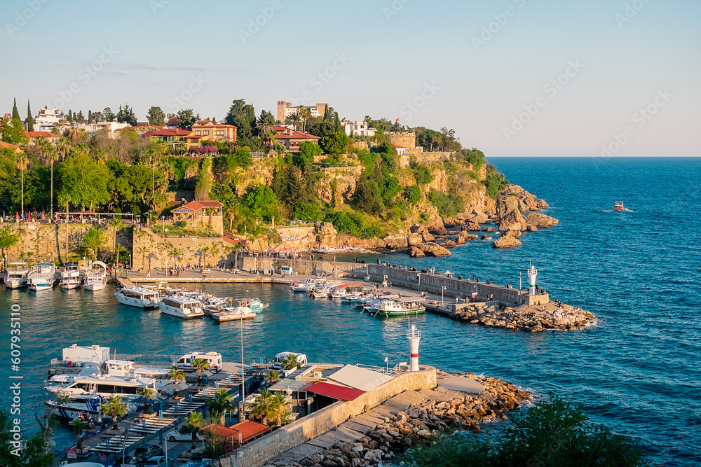 View from a height of the harbor near the old town of Kaleichi in the Turkish city of Antalya. Old port in Antalya with many ships and boats. Popular tourist place in Anatalya.