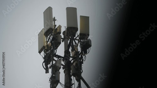 Cell tower antennas transmitting data, repeaters for mobile communications and the Internet, GPS, cellphone, 3G, 4G and 5G telecommunication tower with clear sky. photo