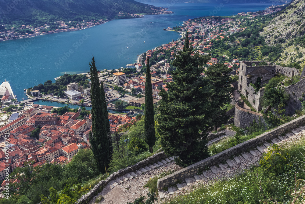 Tourist path to ancient Old Town ruins around St John Fortress above historic part of Kotor town, Montenegro