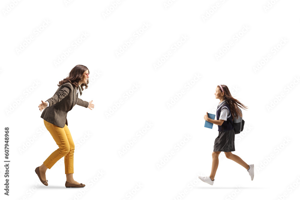 Schoolgirl running to hug a young woman Schoolgirl running to hug a young woman
