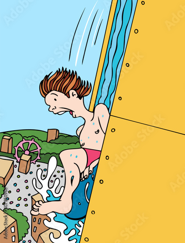 Boy rides down a steep water slide at an amusement park.