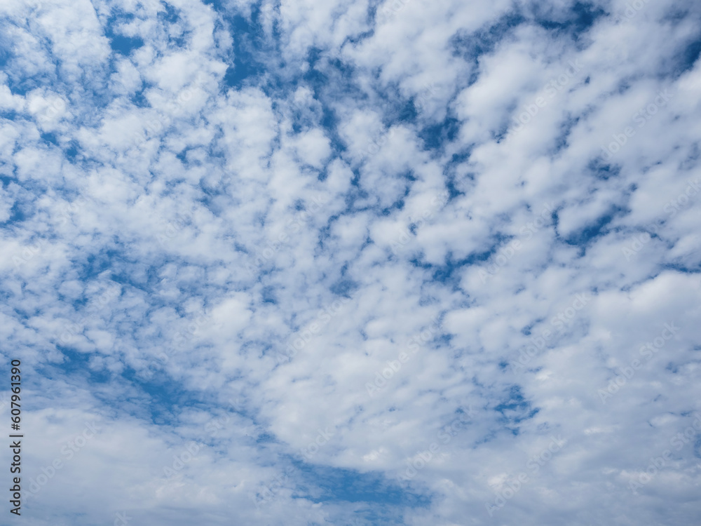 Blue sky with unusual fluffy abstract white clouds structure. Strange dramatic clouds pattern texture. Blue sky with unusual fluffy abstract white clouds structure. Strange dramatic clouds pattern texture.
