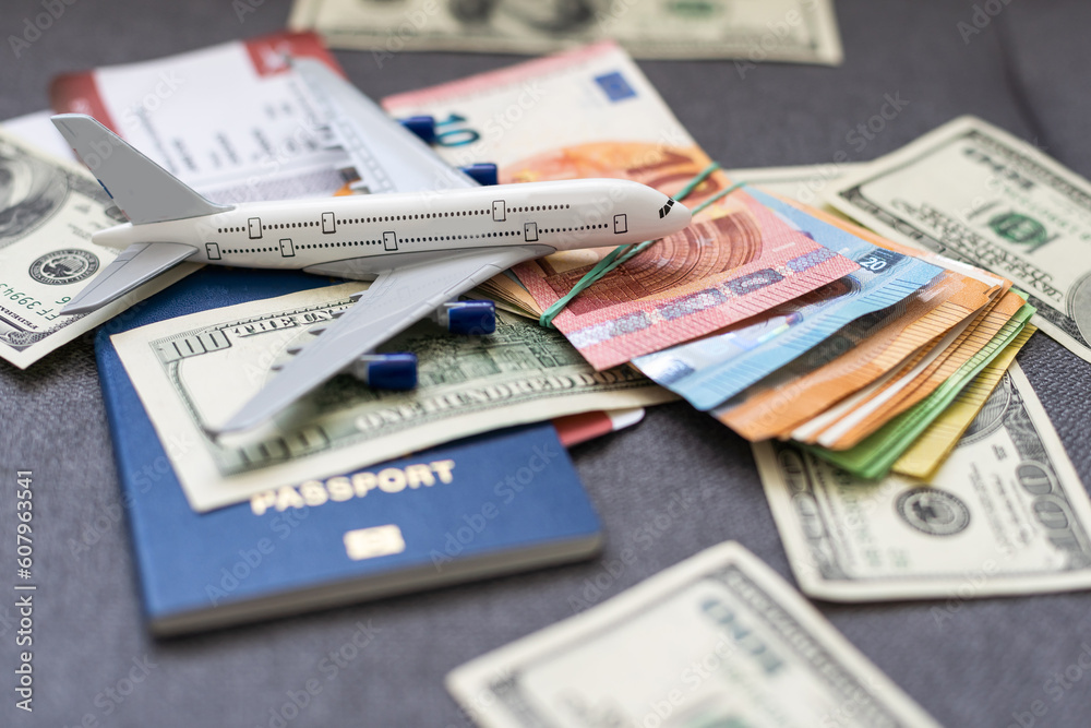Toy plane on Euro cash background, travel with airplane. Conceptual image of the price of airline tickets for travel. Selective focue, close-up. Toy plane on Euro cash background, travel with airplane. Conceptual image of the price of airline tickets for travel. Selective focue, close-up.