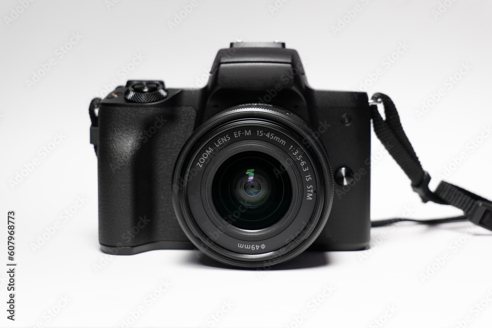 Photo camera body with zoom lens on white background. Media technology and photography concept, photography equipment