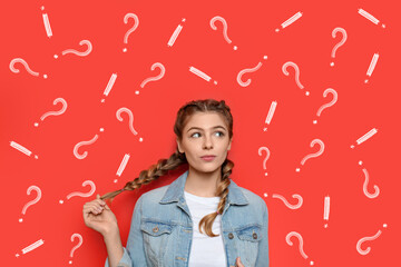 Thoughtful young woman with drawn question and exclamation marks on red background