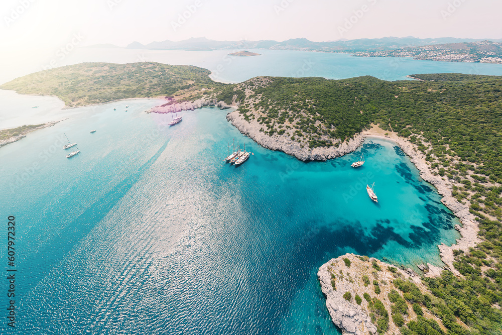 Aerial view of blue sea lagoon and yachts along the Aegean coast. Landscape of turkish riviera nature - obrazy, fototapety, plakaty 