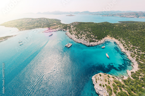 Fototapeta Naklejka Na Ścianę i Meble -  Aerial view of blue sea lagoon and yachts along the Aegean coast. Landscape of turkish riviera nature