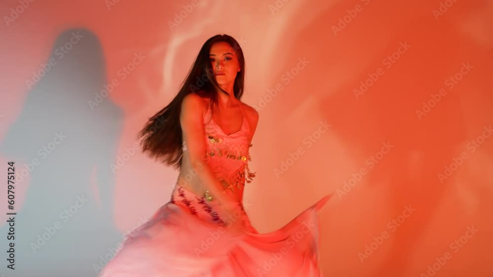 Beautiful Asian woman dancing oriental arabic dance in flowing long skirt. Beautiful Asian woman dancing oriental arabic dance in flowing long skirt.
