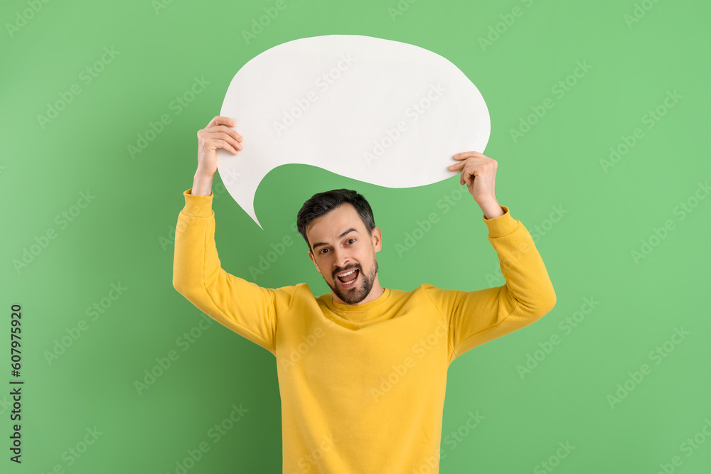Handsome man with blank speech bubble on green background Handsome man with blank speech bubble on green background