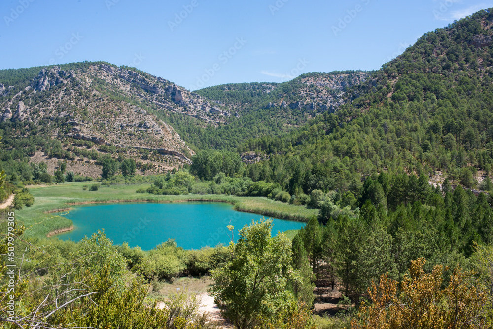 Beautiful landscape with mountains forest, and turquoise lake. Guadalajara, Spain