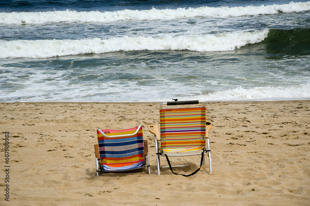 Obraz premium Colorful beach chairs on the beach in Spring Lake, New Jersey 
