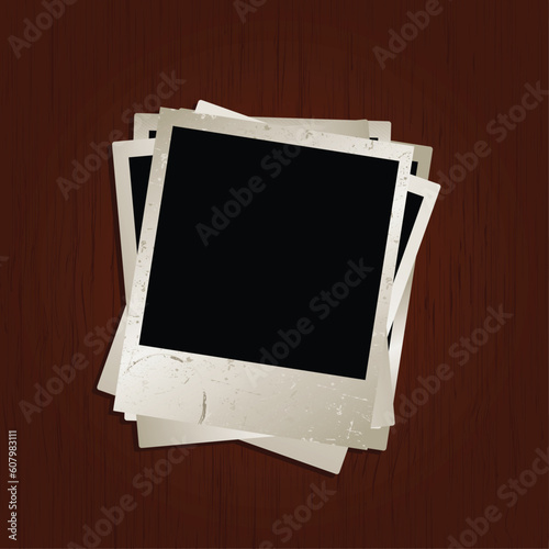 Blank photos on wooden background with a grunge texture on top photo
