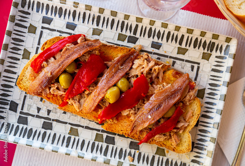 Appetizing spanish sandwich with anchovy and baked bell pepper, Torradas de atun y anchoas