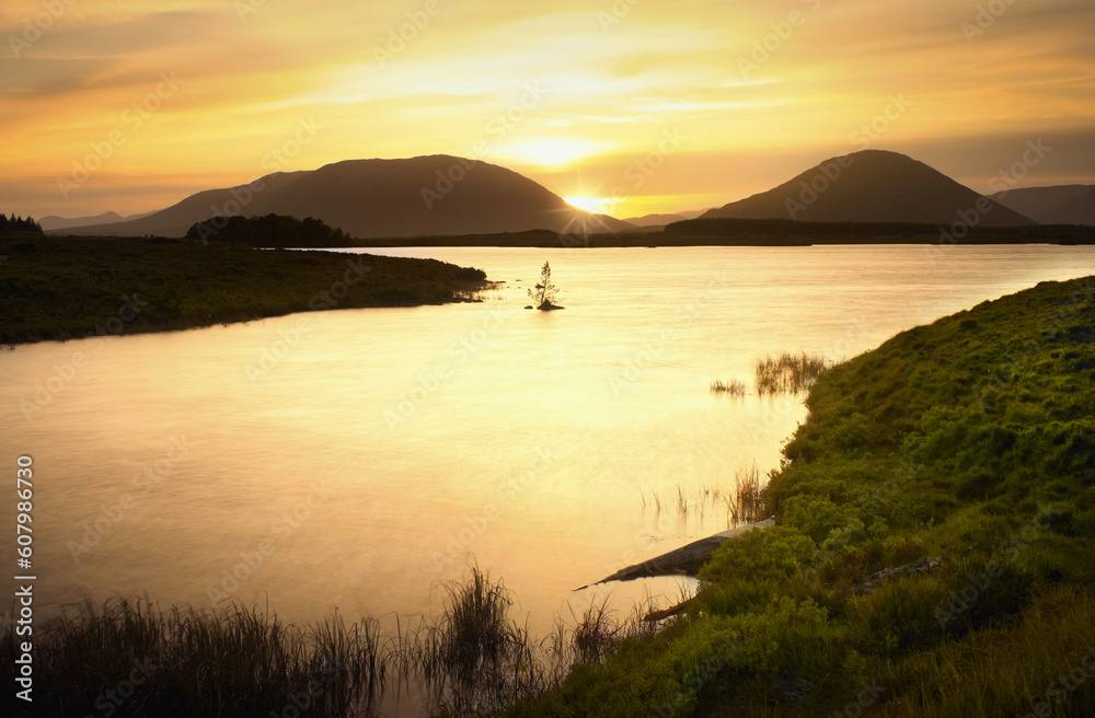 Golden hour landscape scenery with lake and mountains at Connemara National park in County Galway, Ireland 