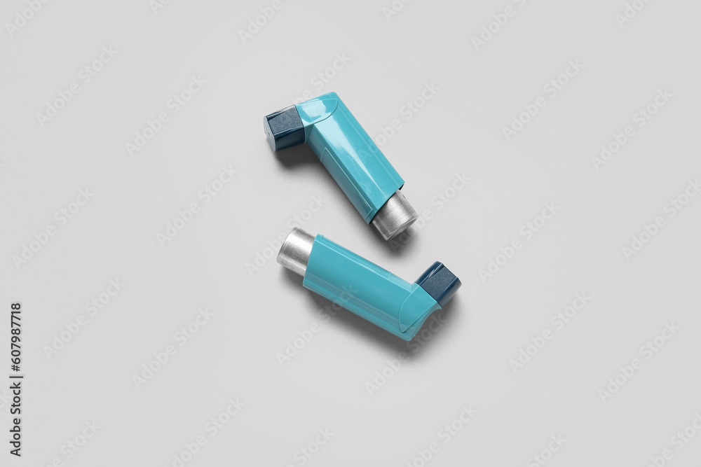 Asthma inhalers on grey background Asthma inhalers on grey background