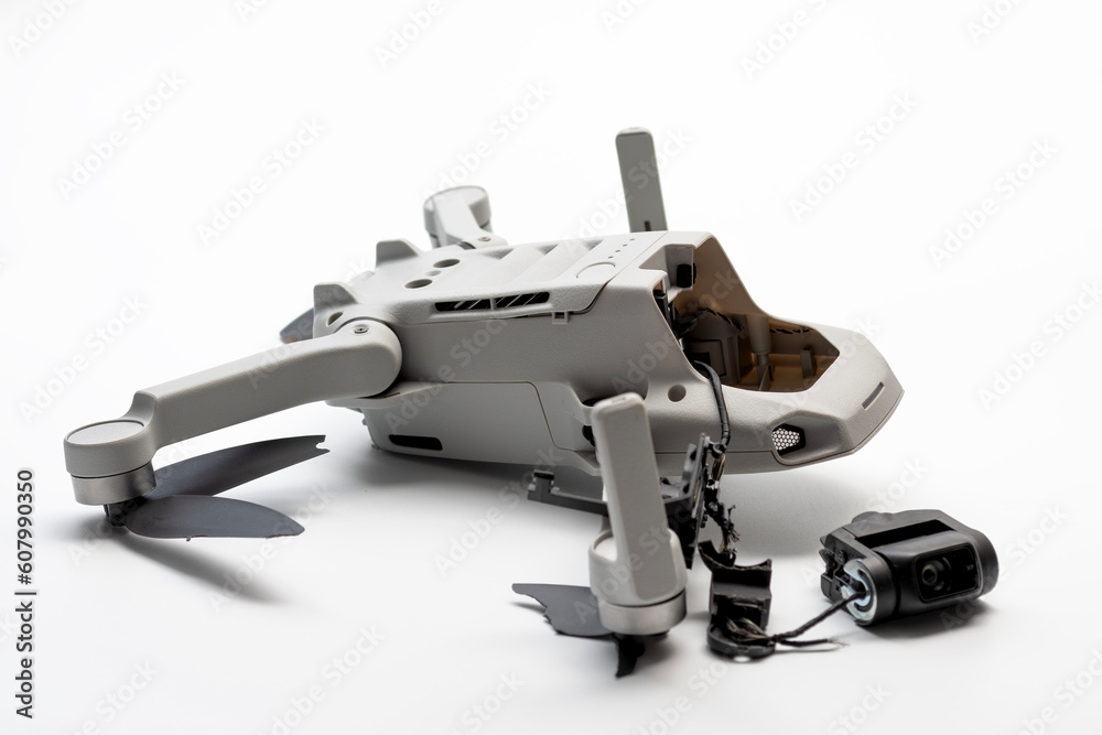 Naklejka premium Crashed Drone With Scratched Camera and Broken Propellers Isolated on White Background With Clipping Path Cut Out Concept for Accident Impact Assessment, Aerial Hobby Hazards and Flying Failures