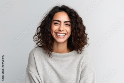Portrait of a happy young woman smiling at camera isolated over white background
