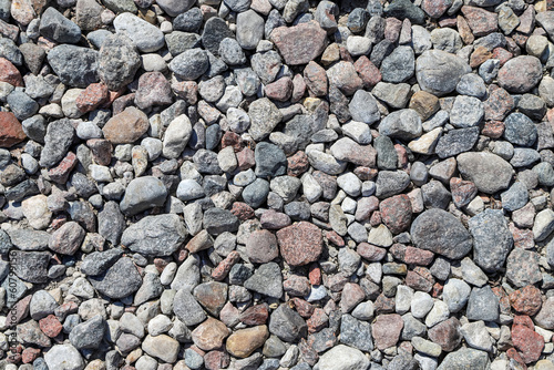 White, gray and pink stones on a cobble beach as a natural background