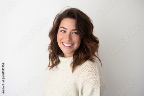 Portrait of a beautiful young woman with long brown hair in a white sweater