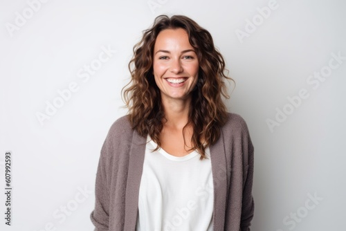 Portrait of a smiling young woman standing over white background. Looking at camera