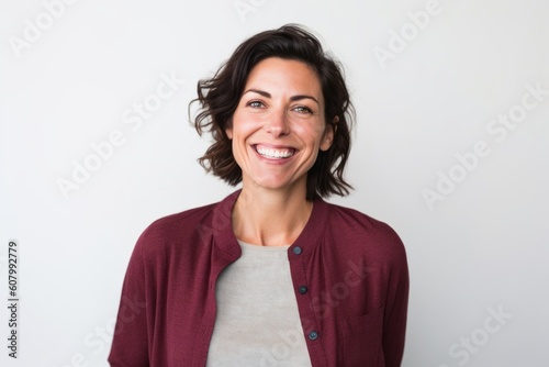Portrait of happy woman smiling at camera on white background in studio © Robert MEYNER