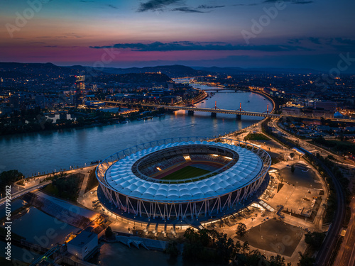 Budapest, Hungary - Aerial skyline view of Budapest at dusk, with National Athletics Centre, Rakoczi bridge over River Danube and MOL Campus skyscraper building at background with colorful sunset sky
