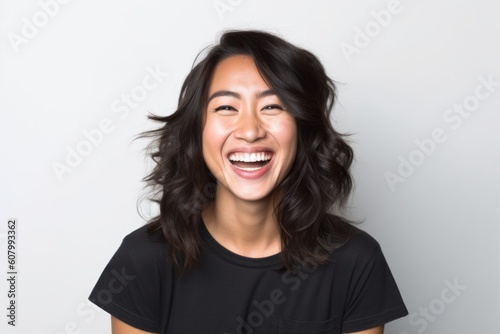 Group portrait photography of a grinning woman in her 30s that is placed against a white background . Generative AI © Robert MEYNER