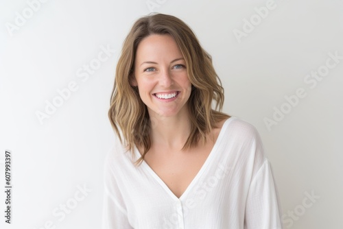 Portrait of a beautiful young woman smiling at camera on white background