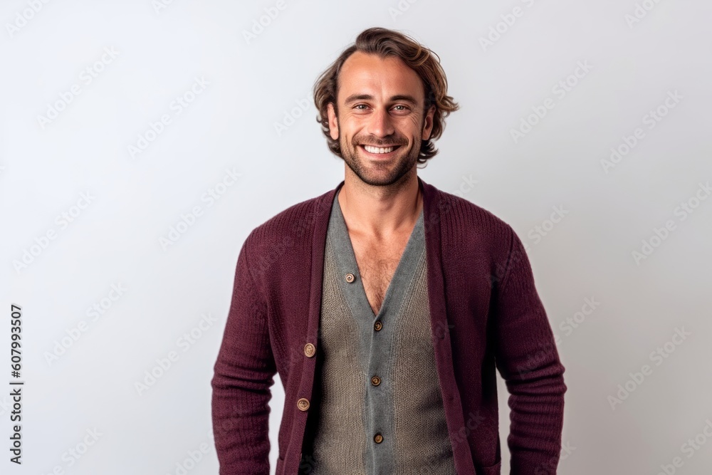 Portrait of a handsome young man smiling while standing against white background Portrait of a handsome young man smiling while standing against white background
