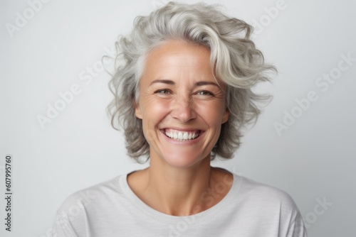 Close up portrait of a smiling middle-aged woman with grey hair