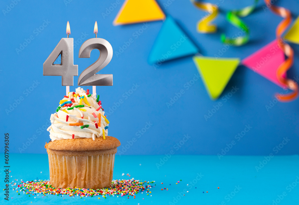 Birthday cake with candle number 42 - Blue background