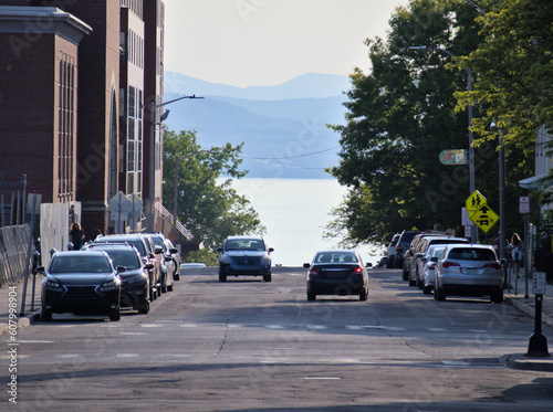 cars driving on street with hills in background in vermont