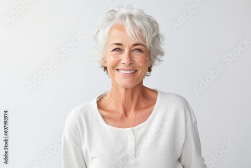 Medium shot portrait photography of a satisfied woman in her 60s that is placed against a white background . Generative AI